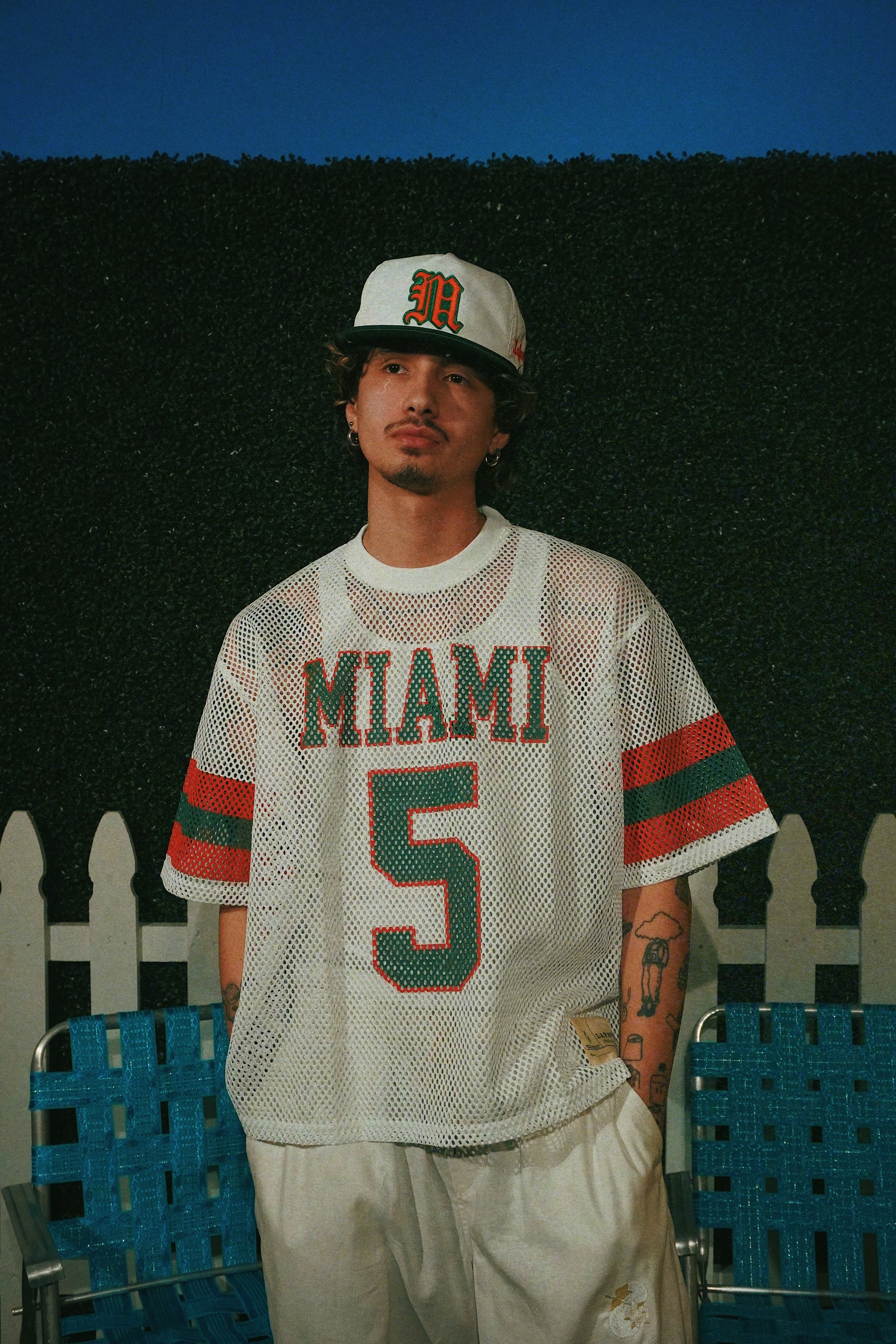 Person wearing a 'Miami' jersey with number 5 against a dark background