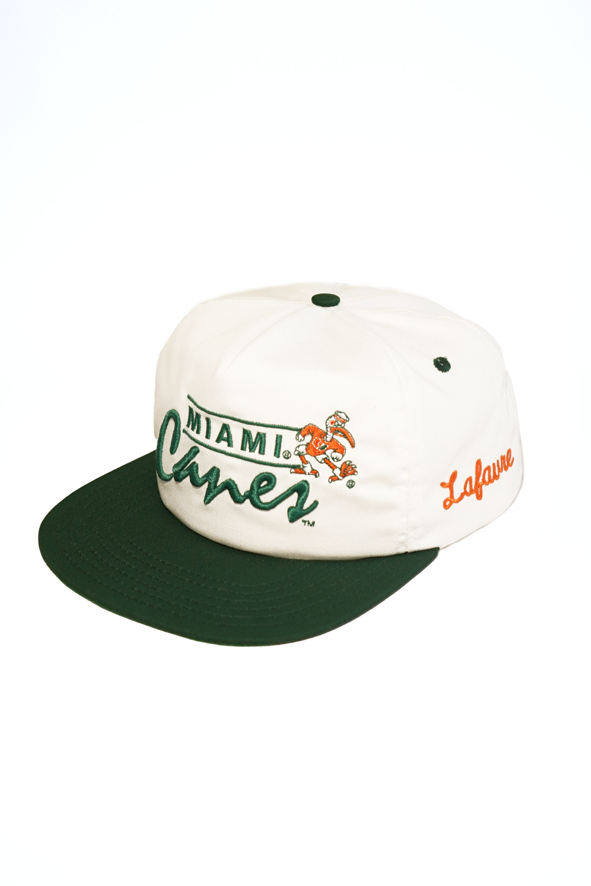 White and green cap with 'Miami Hurricanes' and 'Lafavre' branding on a white background