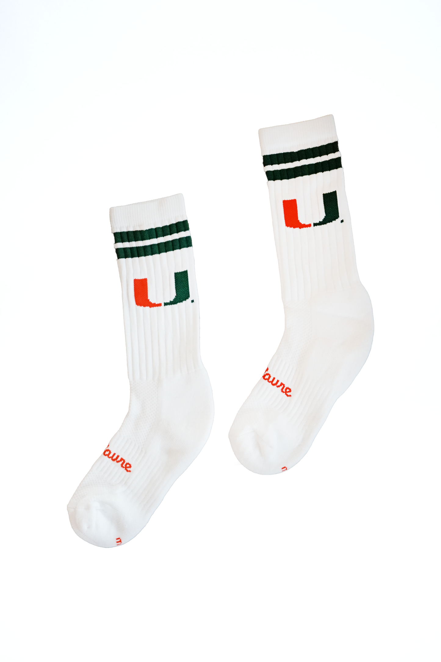 Two white socks with black and green stripes and red text on a white background